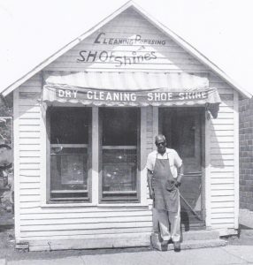 Al Peters in front of his business